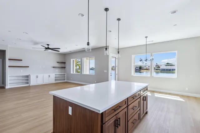 a kitchen with kitchen island a sink appliances and wooden floor