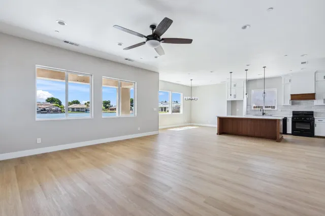a view of a kitchen with furniture and wooden floor