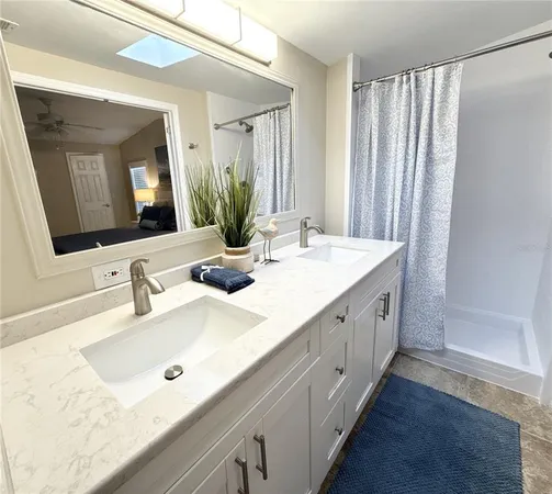 a bathroom with a double vanity sink and mirror