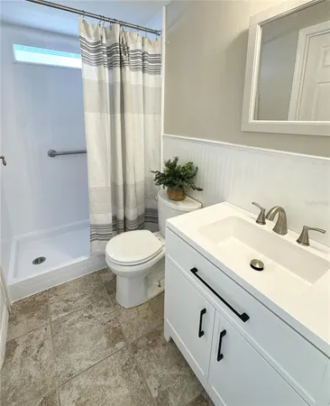 a bathroom with a sink toilet and shower
