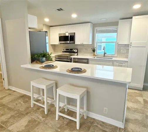 a kitchen with a sink cabinets and window
