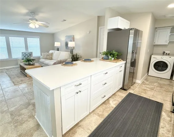 a view of a kitchen counter space with furniture and wooden floor