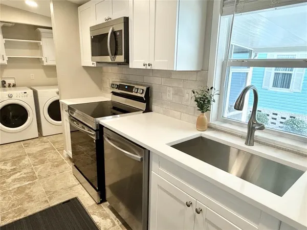 a kitchen that has a sink and a stove