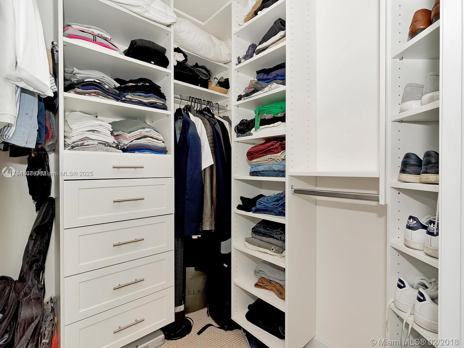 250 Sunny Isles Boulevard, Unit 31403 Sunny Isles Beach, FL 33160 - Photo 13 of 24 a view of walk in closet with clothes and shoes