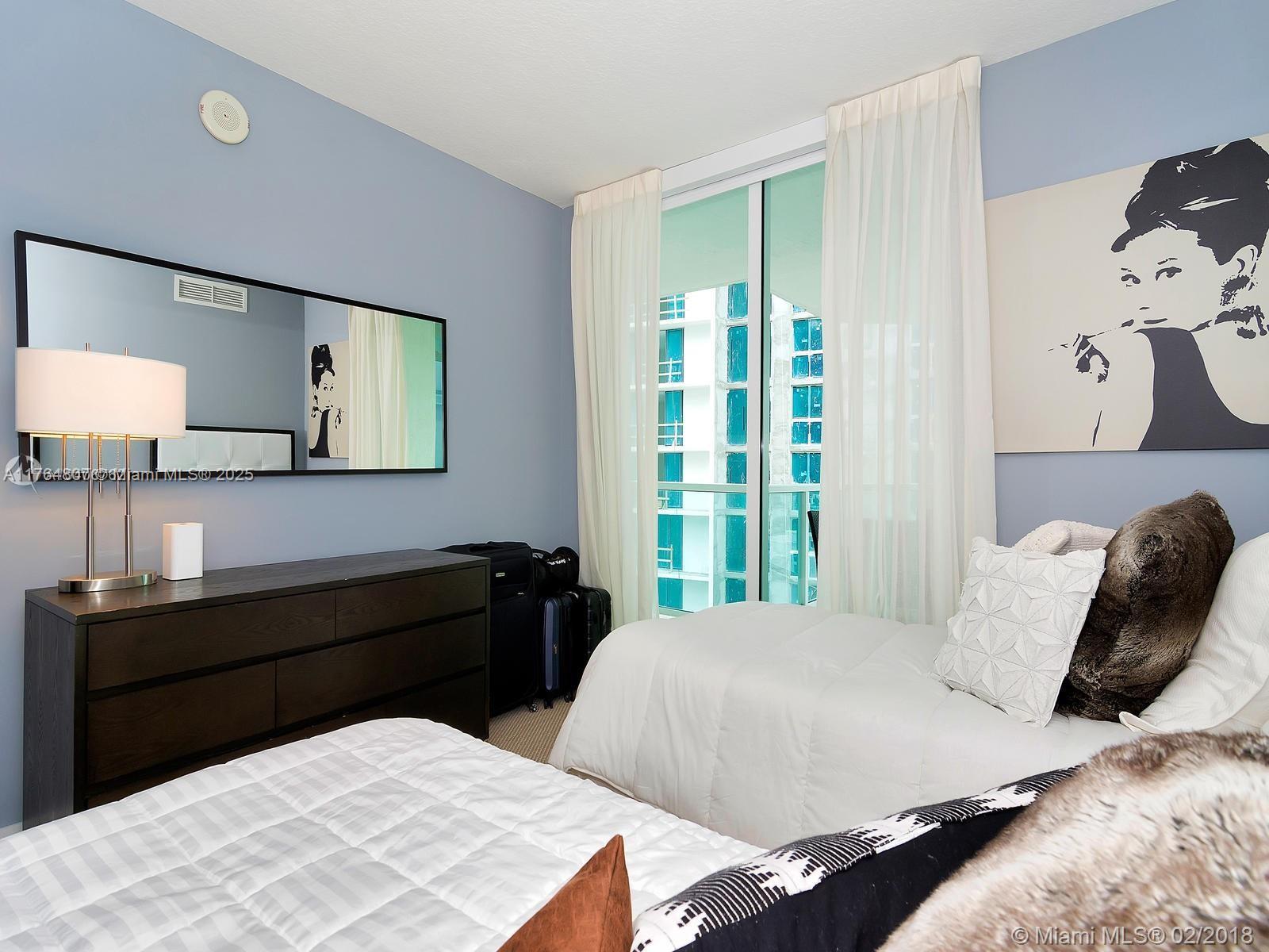 250 Sunny Isles Boulevard, Unit 31403 Sunny Isles Beach, FL 33160 - Photo 14 of 24 a bedroom with a bed and window