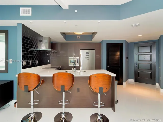 a dining room with chairs and chandelier