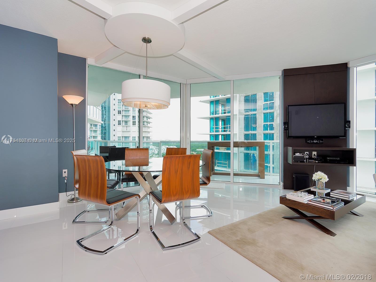 250 Sunny Isles Boulevard, Unit 31403 Sunny Isles Beach, FL 33160 - Photo 5 of 24 a living room with patio furniture and a flat screen tv