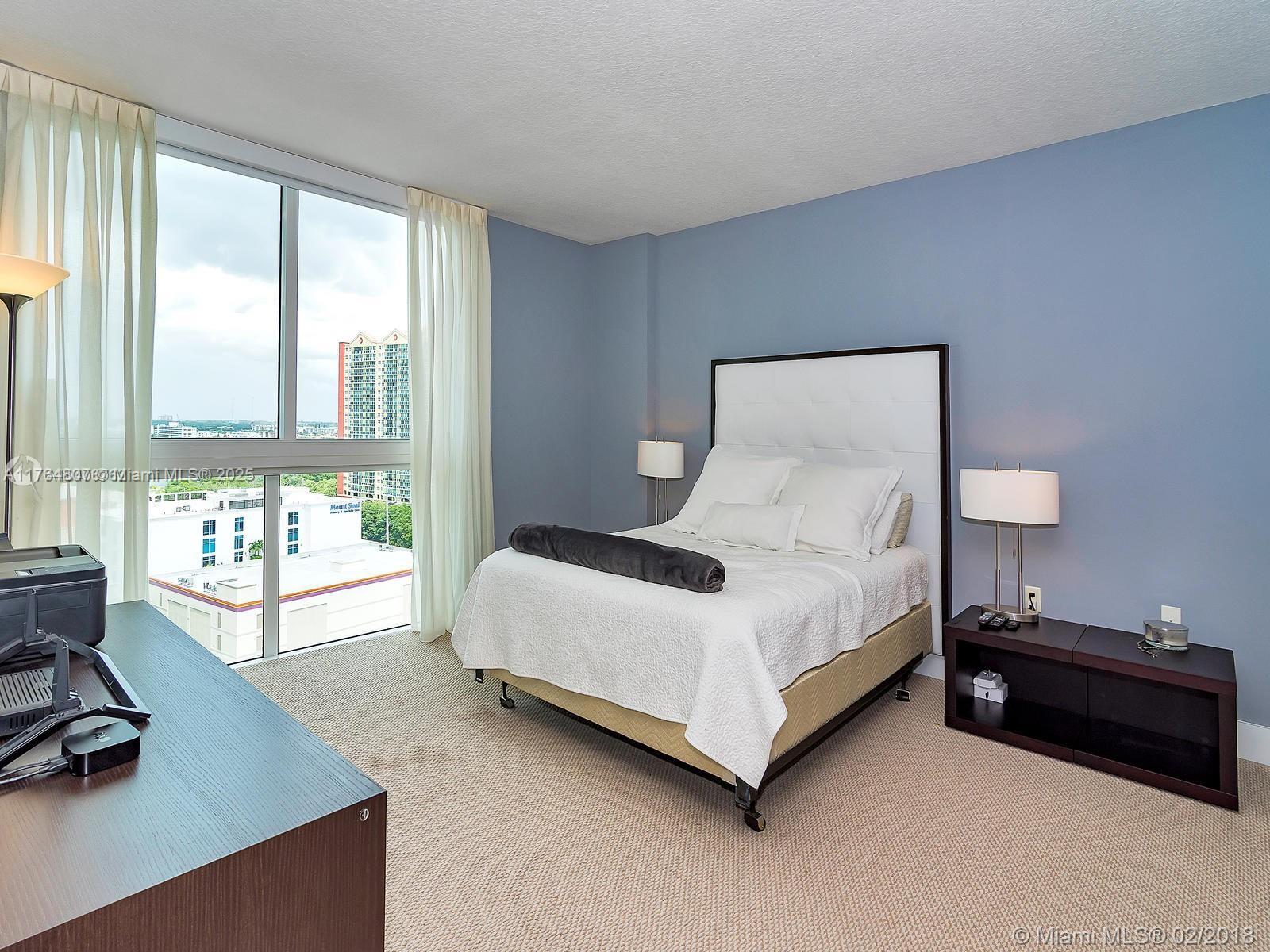 250 Sunny Isles Boulevard, Unit 31403 Sunny Isles Beach, FL 33160 - Photo 8 of 24 a spacious bedroom with a bed and a large window