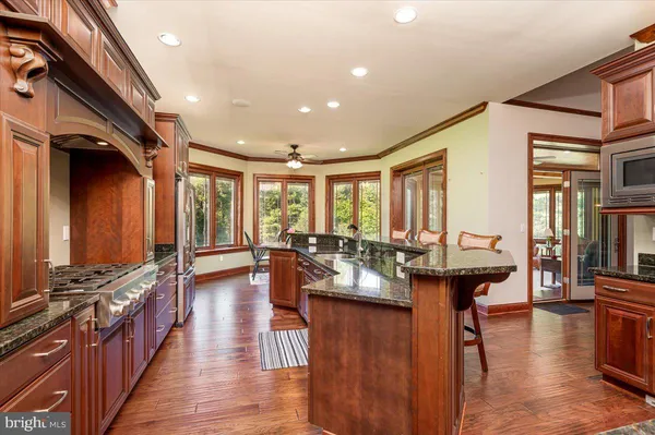 a living room with fireplace furniture and a large window