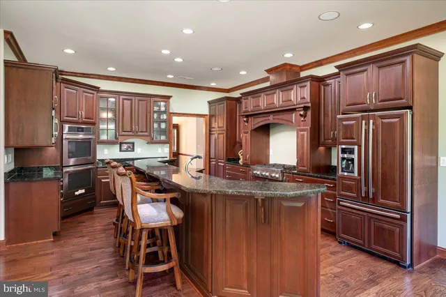 a spacious bedroom with a bed and a chandelier