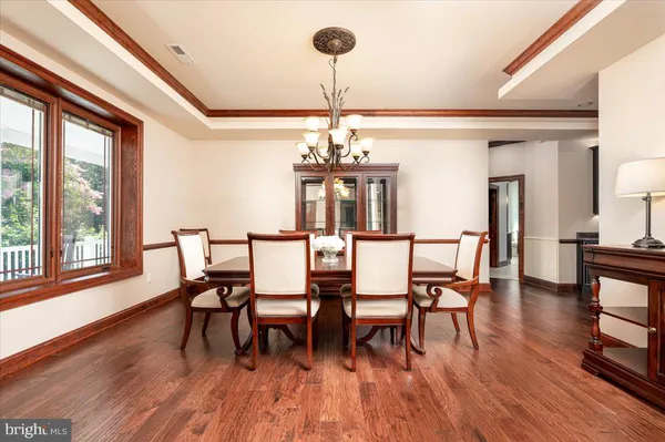 a bed sitting in a spacious bedroom next to a window