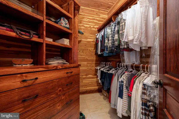 a spacious bedroom with a bed and a chandelier