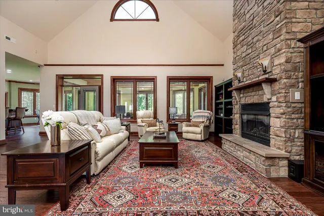 a kitchen with kitchen island granite countertop wooden cabinets and a refrigerator