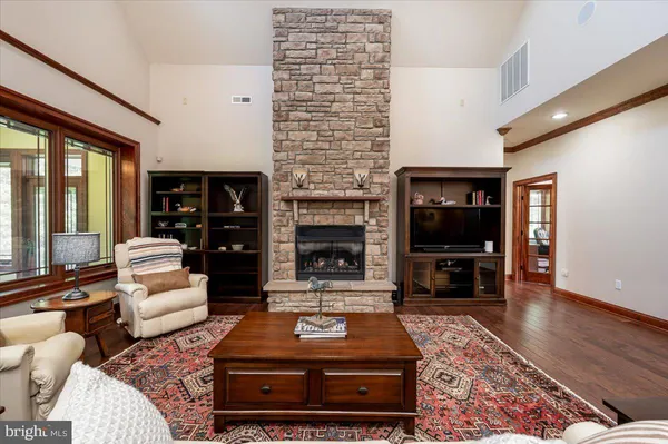 a kitchen with kitchen island granite countertop wooden cabinets and stainless steel appliances