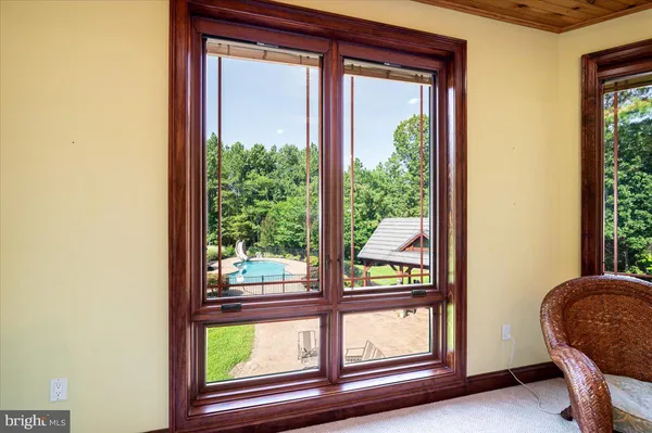 a dining room with furniture a chandelier and wooden floor