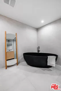 a room with painting and a lamp