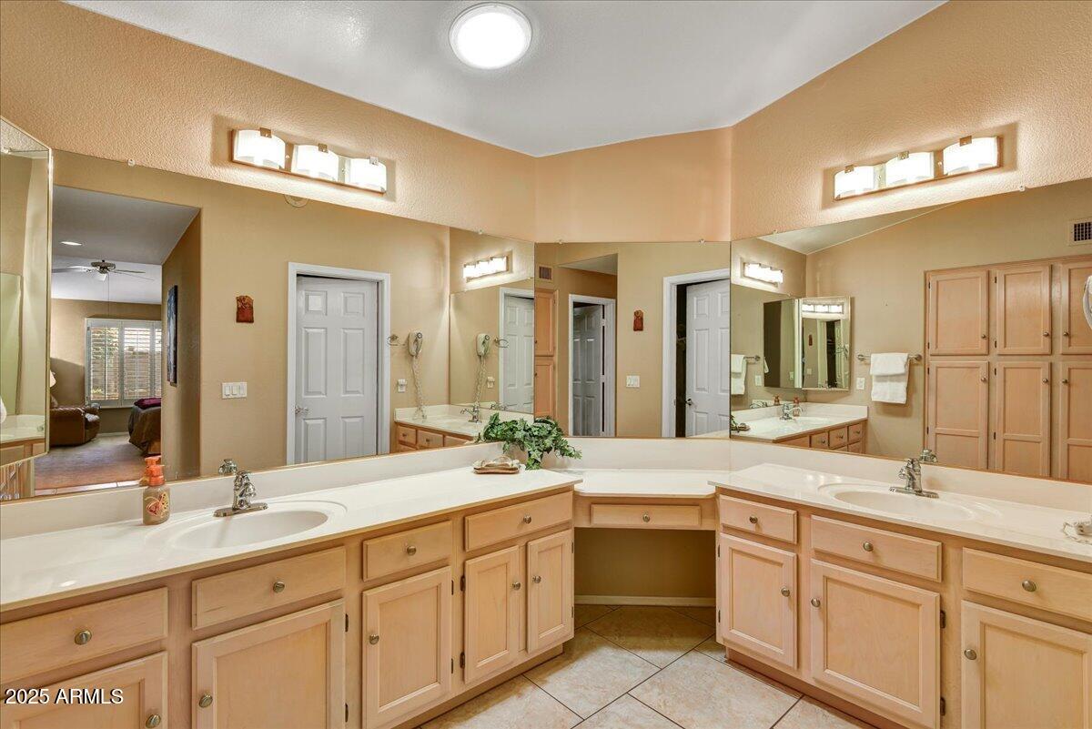 9013 West Marco Polo Road Peoria, AZ 85382 - Photo 13 of 30 a bathroom with a double vanity sink and a mirror
