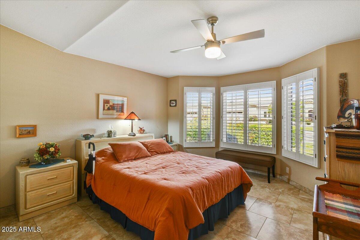 9013 West Marco Polo Road Peoria, AZ 85382 - Photo 14 of 30 a bedroom with a bed and a large window