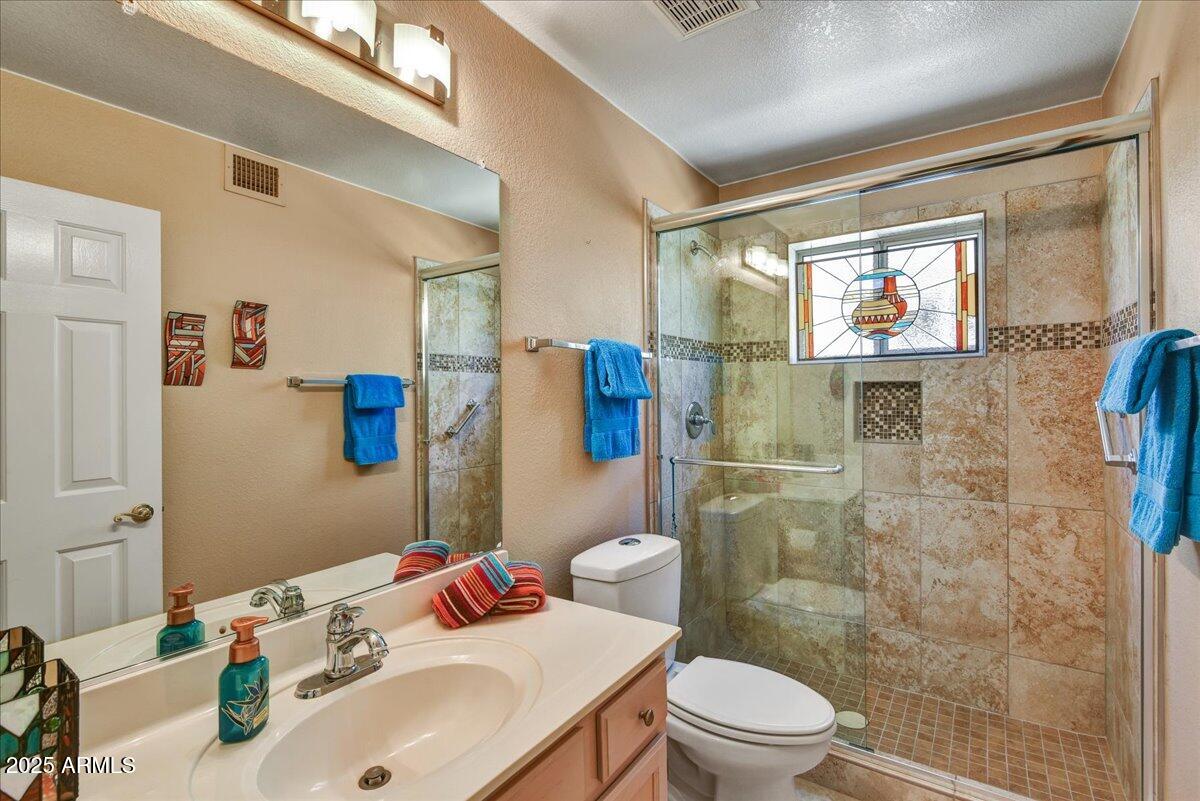 9013 West Marco Polo Road Peoria, AZ 85382 - Photo 15 of 30 a bathroom with a sink toilet and shower
