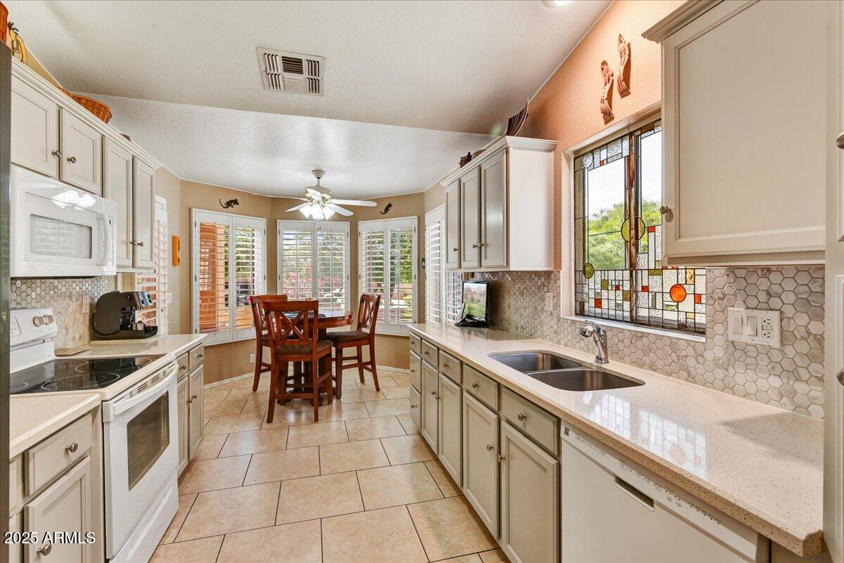 9013 West Marco Polo Road Peoria, AZ 85382 - Photo 8 of 30 a kitchen with stainless steel appliances granite countertop a sink and cabinets
