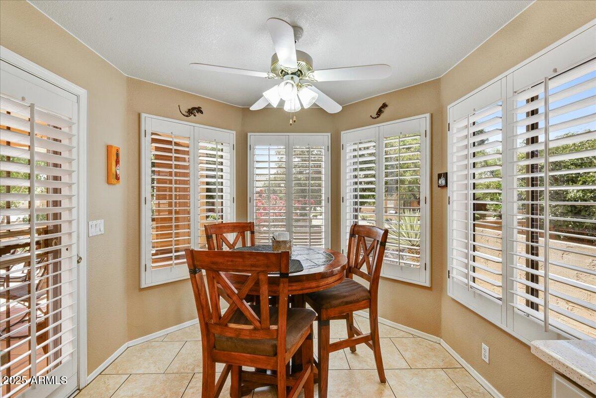 9013 West Marco Polo Road Peoria, AZ 85382 - Photo 9 of 30 a dining room with furniture a chandelier and a rug