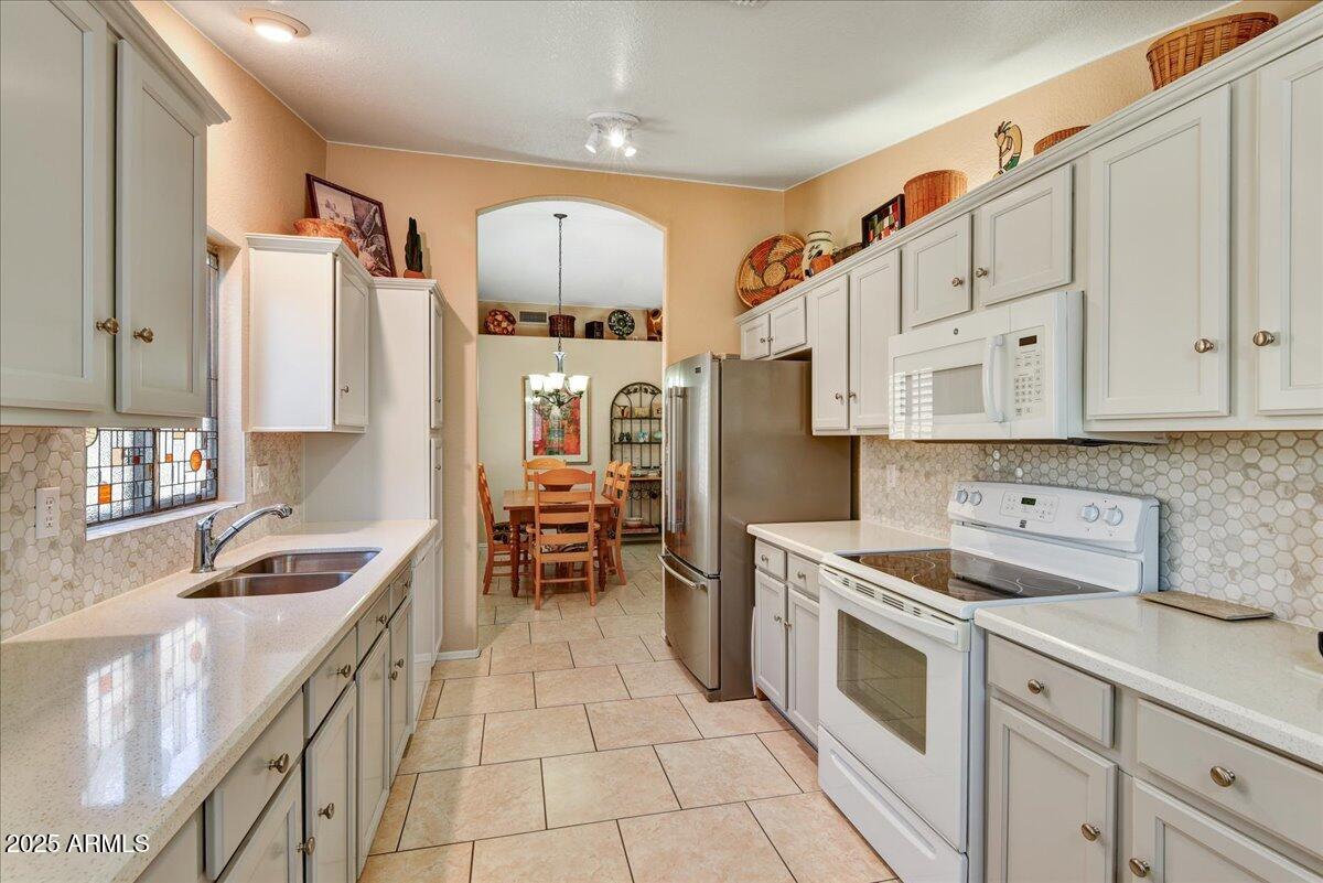 9013 West Marco Polo Road Peoria, AZ 85382 - Photo 10 of 30 a kitchen with white cabinets and appliances