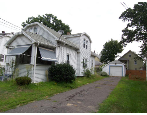 a front view of house with a garden