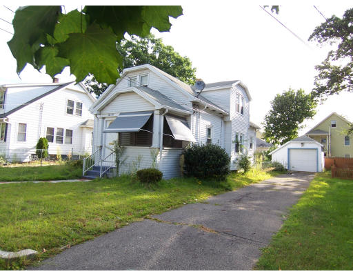 59 Redlands Street Springfield, MA 01104 - Photo 2 of 3 a front view of a house with a garden and yard