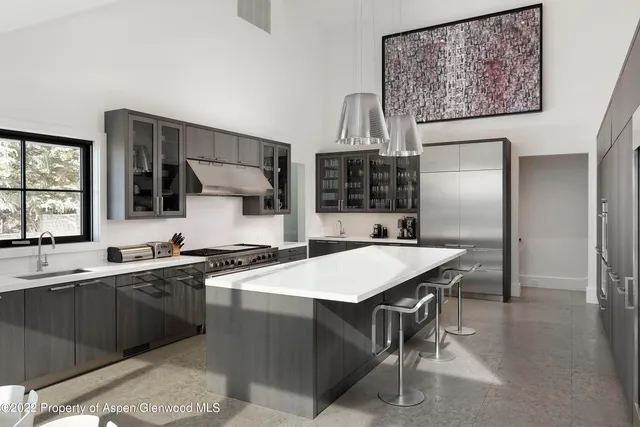 a kitchen with a sink a counter top space and stainless steel appliances