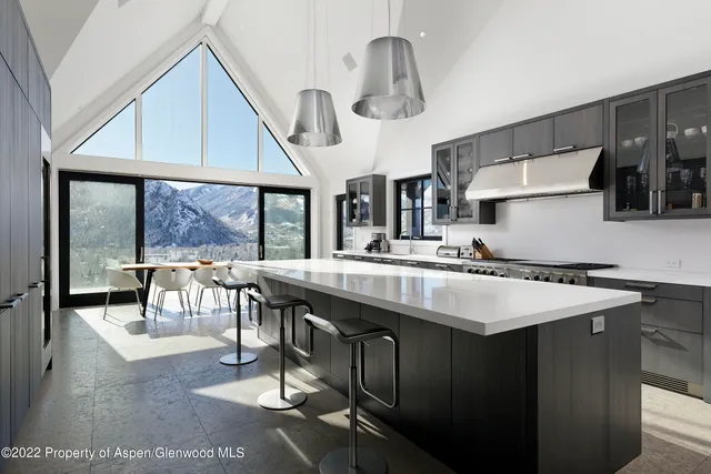 a kitchen with stainless steel appliances granite countertop a sink a stove and a refrigerator