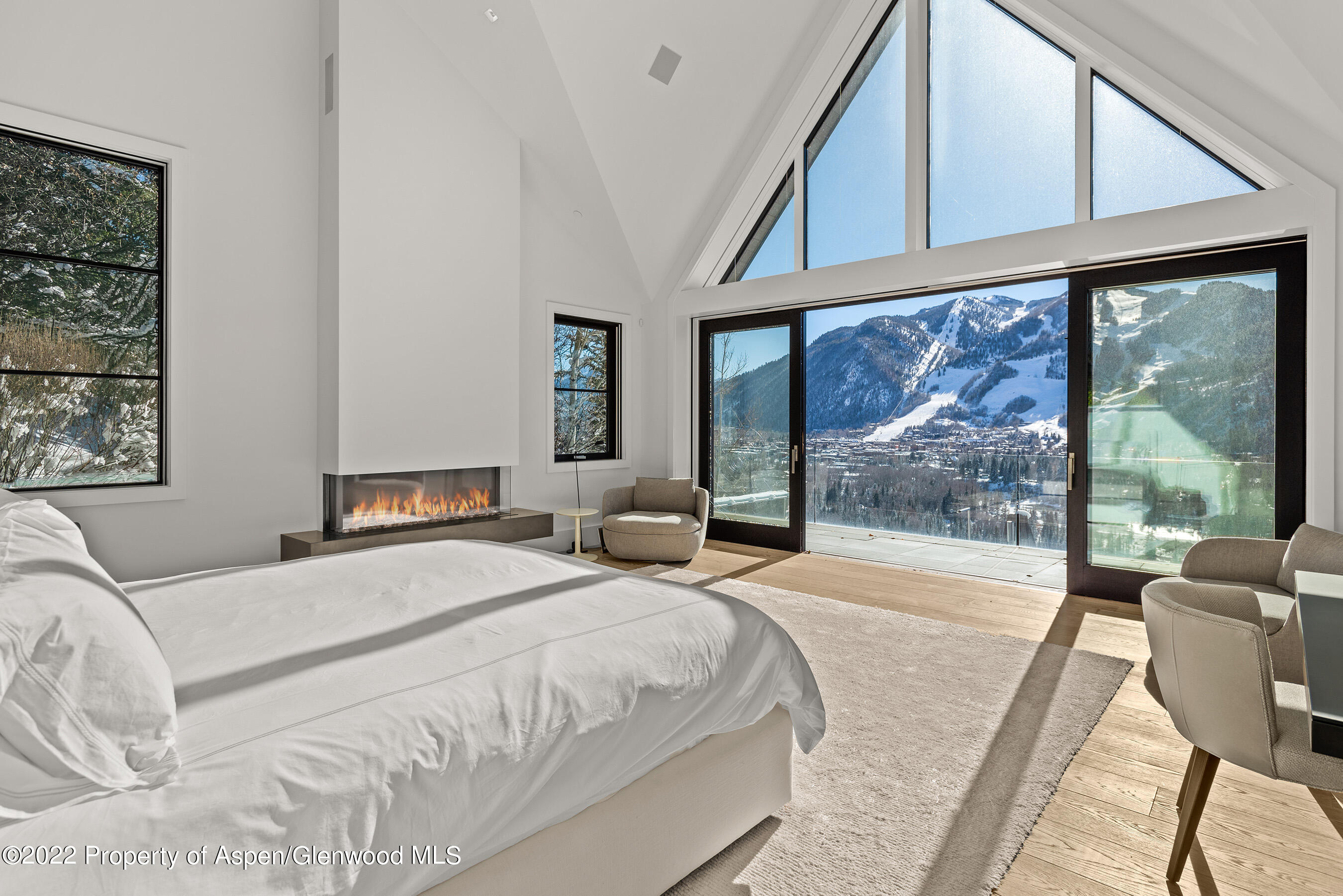 257 Ridge Road Aspen, CO 81612 - Photo 16 of 47 a bedroom with a large bed and a balcony with furniture