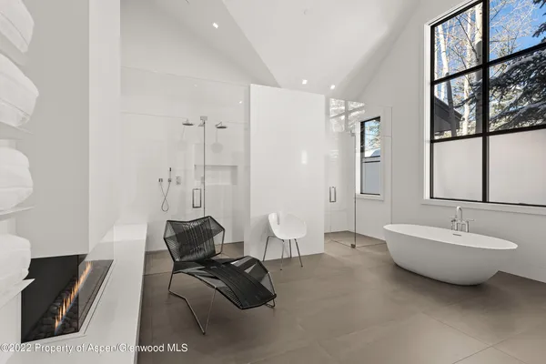 a spacious bathroom with a double vanity sink a mirror and a bathtub
