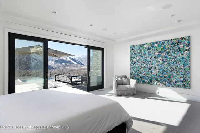 a bedroom with a large bed and a large window