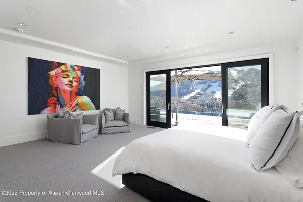 a bedroom with furniture and large window