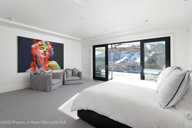 a bedroom with furniture and large window