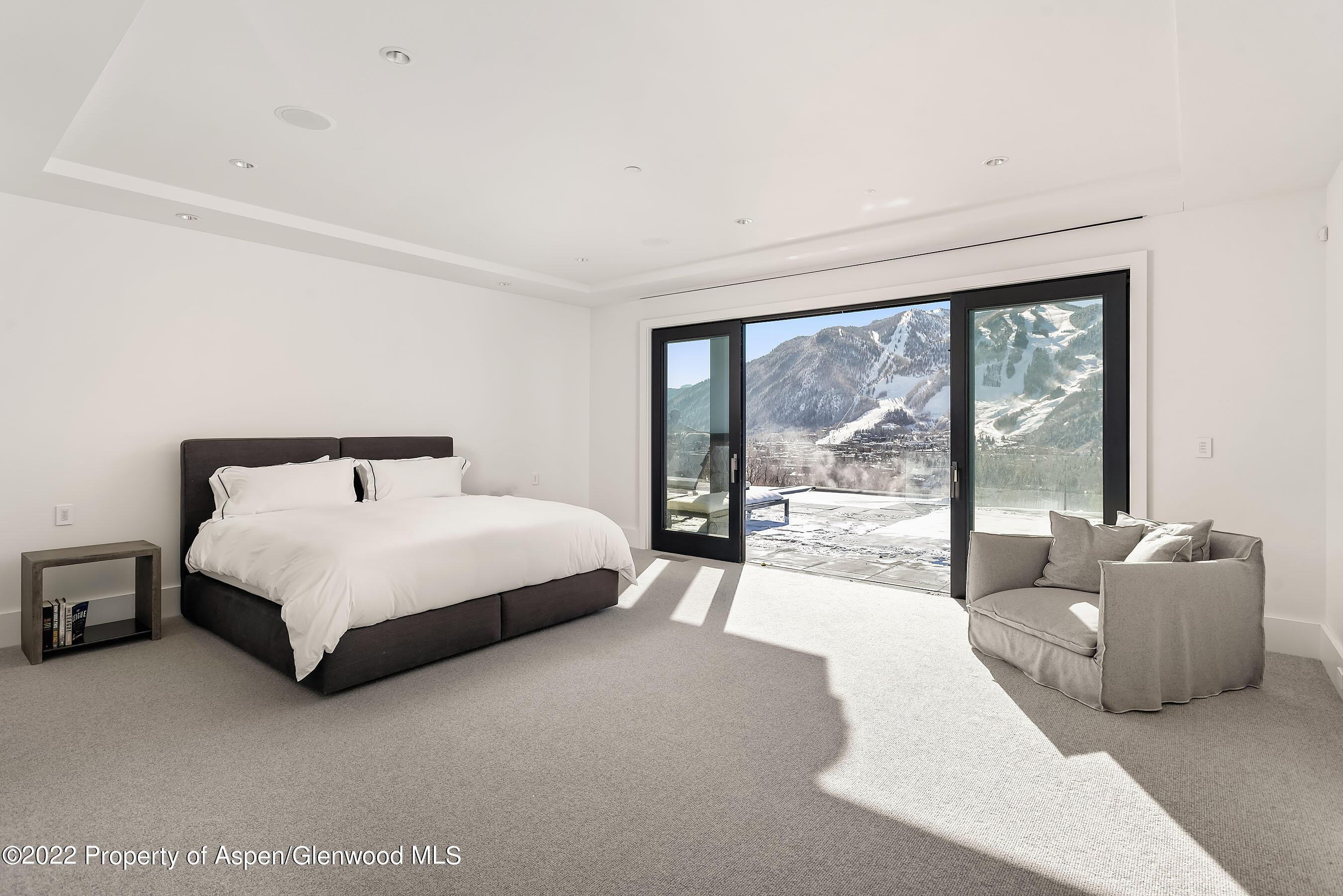 257 Ridge Road Aspen, CO 81612 - Photo 25 of 47 a spacious bedroom with a bed and a large window