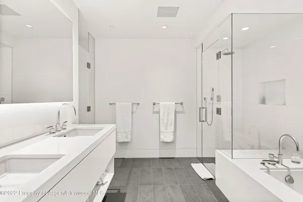 a bathroom with double vanity sink and a mirror