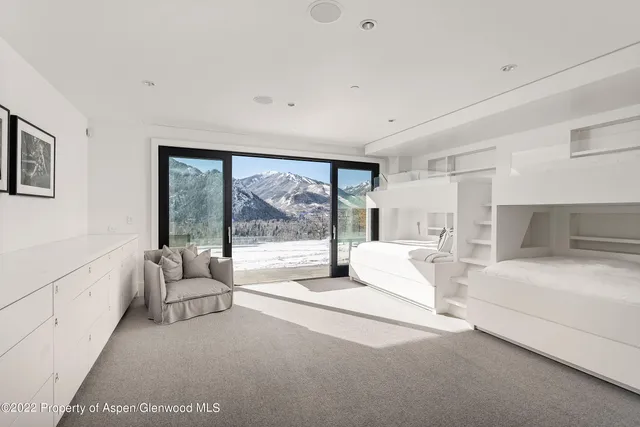 a spacious bedroom with a large bed and a large window