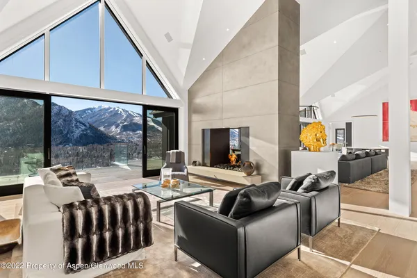 a living room with furniture fireplace and flat screen tv