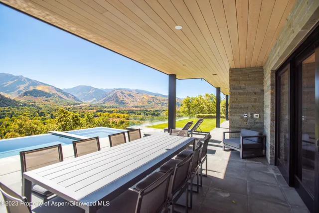 a view of a balcony with table and chairs