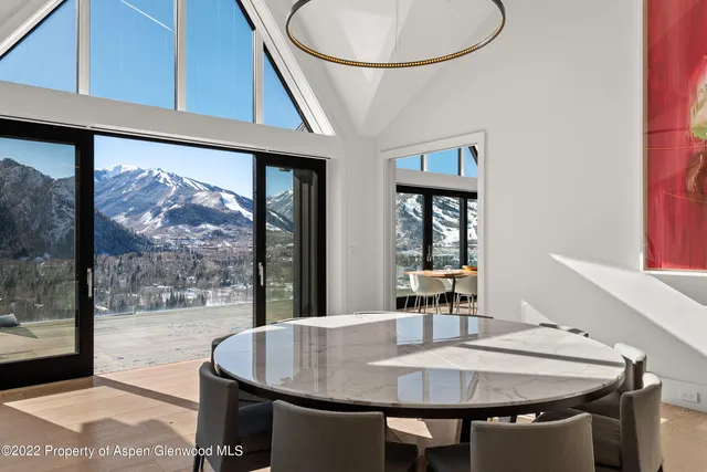 a dining table with chairs and window