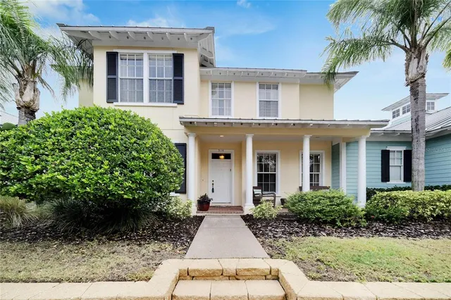 a view of a white building among the palm trees