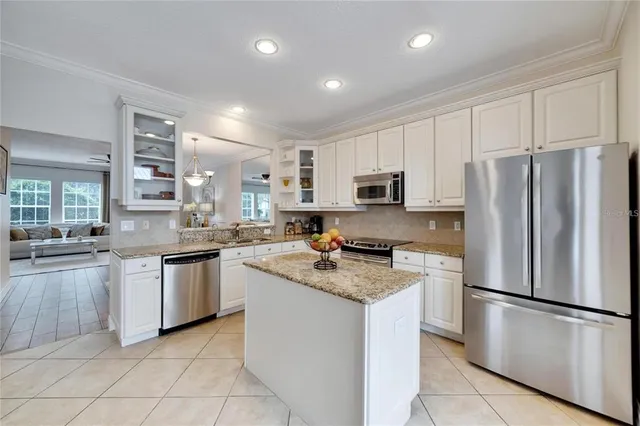a kitchen with stainless steel appliances granite countertop a refrigerator stove microwave and sink