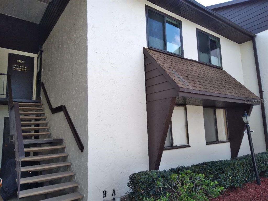 516 Bahia Circle, Unit B Ocala, FL 34472 - Photo 1 of 1 a view of a house with wooden stairs