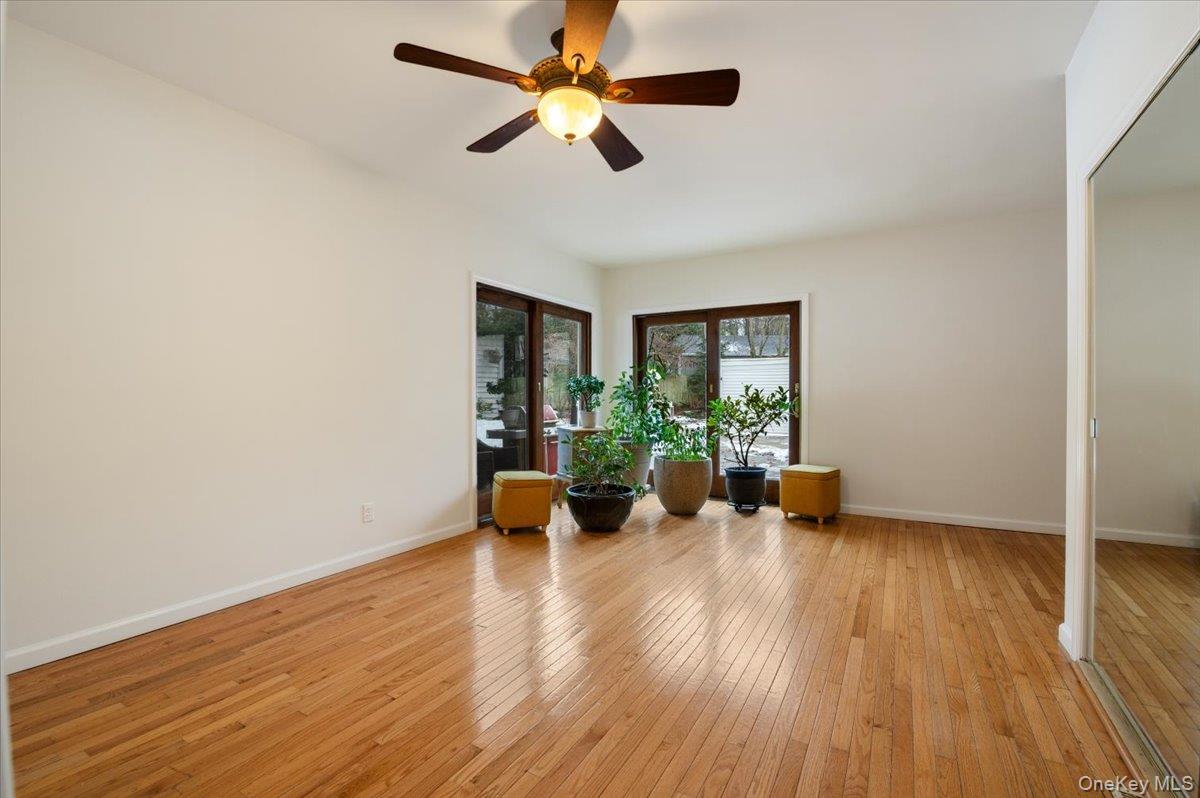 33 Fleets Cove Road Huntington, NY 11743 - Photo 20 of 42 Living area featuring light wood-style floors and ceiling fan