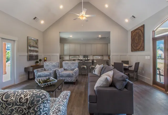 a living room with furniture and wooden floor