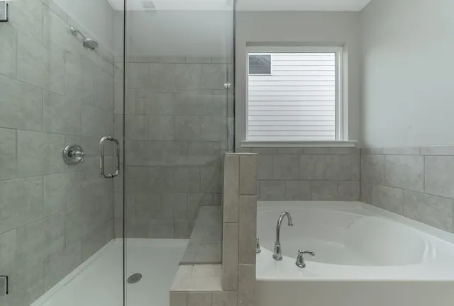 a bathroom with a bathtub and a shower