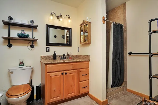 a bathroom with a toilet a sink and a mirror