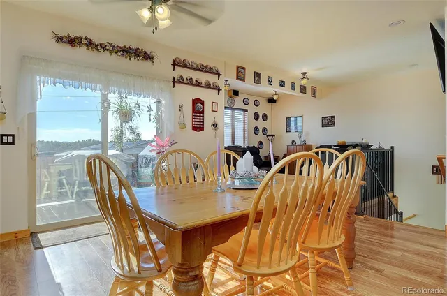 a dining room with furniture a chandelier and wooden floor