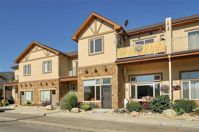 a view of a white house with a clock on the walls